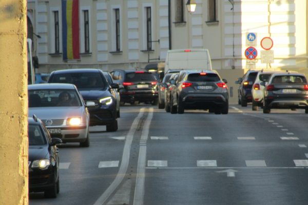 A street filled with lots of traffic next to tall buildings